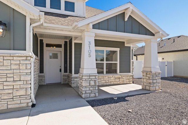 3105 W 3150 N, Plain City, UT 84404 - entrance to property with stone siding, covered porch, roof with shingles, and board and batten siding