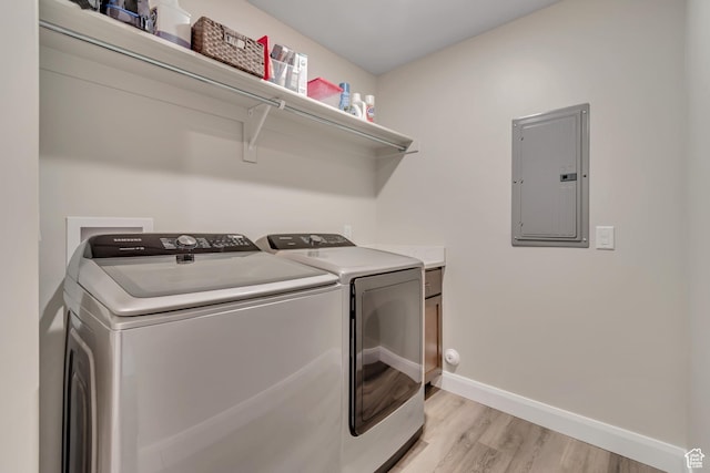 453 S Short Horse Ln Unit C, Saratoga Springs, UT 84045 - washroom with electric panel, light wood-style flooring, separate washer and dryer, and cabinet space