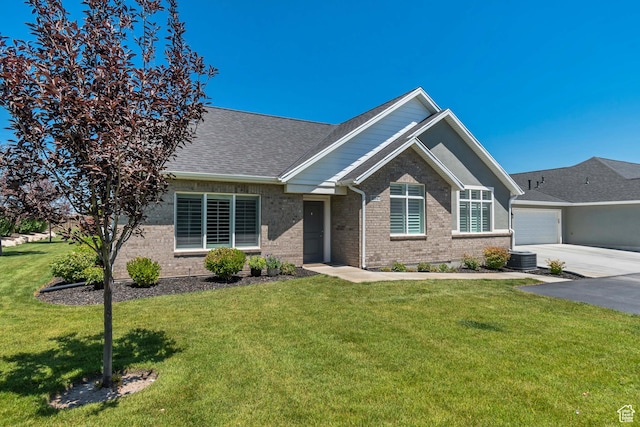 453 S Short Horse Ln Unit C, Saratoga Springs, UT 84045 - view of front of home featuring brick siding, a front yard, a garage, and roof with shingles