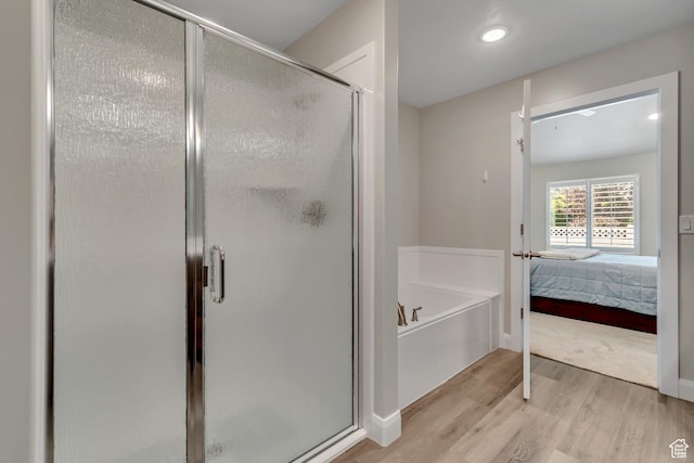 453 S Short Horse Ln Unit C, Saratoga Springs, UT 84045 - bathroom with a bath, wood finished floors, a stall shower, and ensuite bathroom