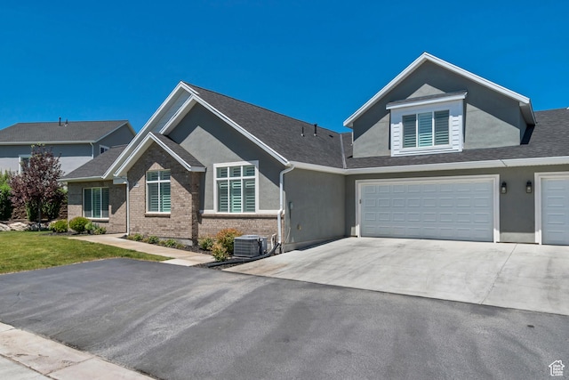 453 S Short Horse Ln Unit C, Saratoga Springs, UT 84045 - view of front facade featuring driveway, a garage, stucco siding, and brick siding
