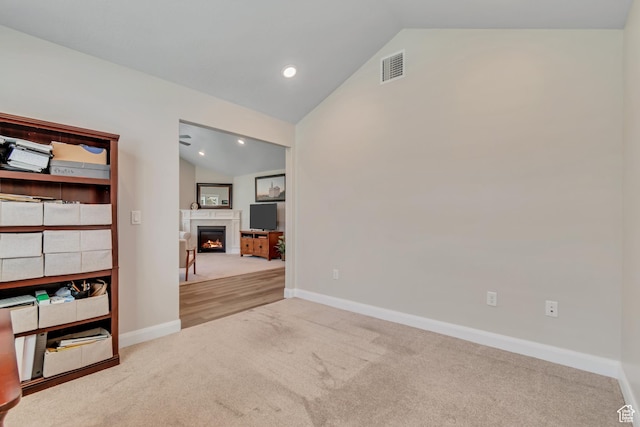 453 S Short Horse Ln Unit C, Saratoga Springs, UT 84045 - carpeted empty room with vaulted ceiling, a lit fireplace, and recessed lighting