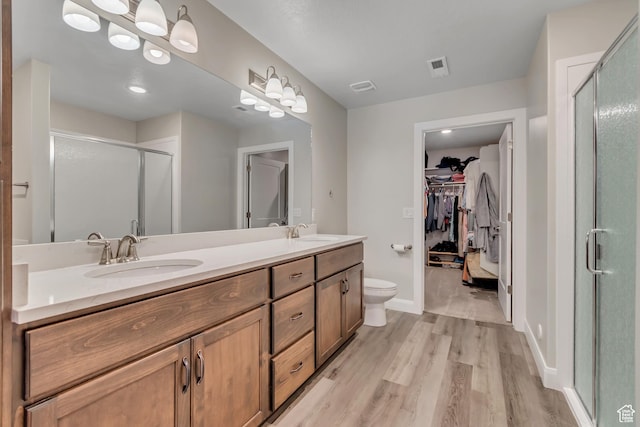 453 S Short Horse Ln Unit C, Saratoga Springs, UT 84045 - bathroom with a shower stall, wood finished floors, double vanity, and a spacious closet