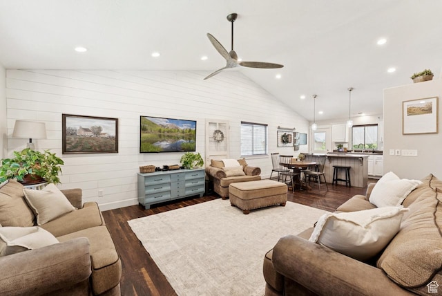 422 W 390 S, Spanish Fork, UT 84660 - living room featuring plenty of natural light, dark wood-type flooring, vaulted ceiling, a ceiling fan, and wooden walls