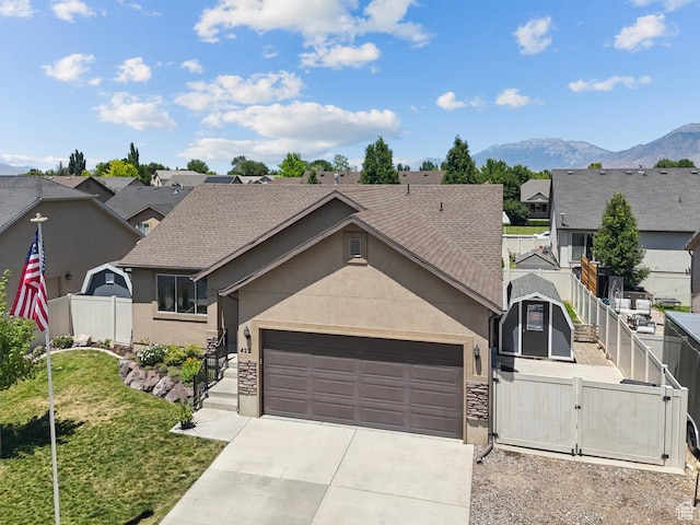 422 W 390 S, Spanish Fork, UT 84660 - view of front of house featuring a gate, stucco siding, concrete driveway, a garage, and a mountain view
