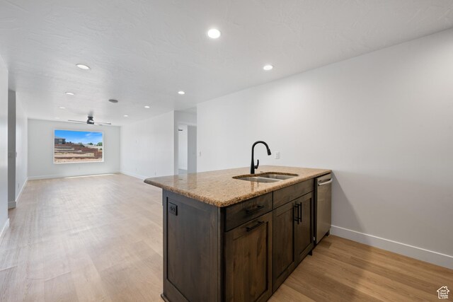 507 N 3650 W, Hurricane, UT 84737 - kitchen with dark brown cabinetry, light stone counters, light wood-style flooring, dishwasher, and a ceiling fan