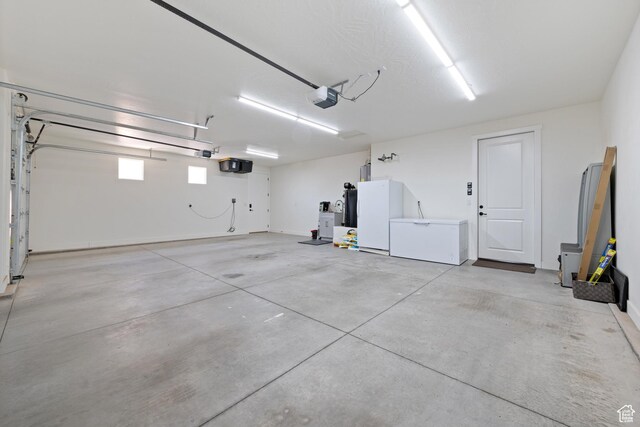 507 N 3650 W, Hurricane, UT 84737 - garage featuring a garage door opener, freestanding refrigerator, and fridge