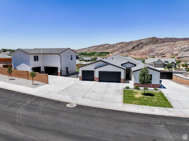 507 N 3650 W, Hurricane, UT 84737 - modern farmhouse style home featuring an attached garage, driveway, a mountain view, board and batten siding, and brick siding