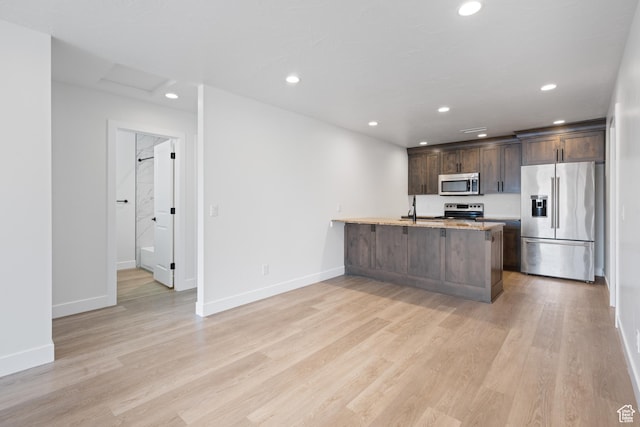 507 N 3650 W, Hurricane, UT 84737 - kitchen featuring appliances with stainless steel finishes, recessed lighting, dark brown cabinets, light wood finished floors, and a peninsula