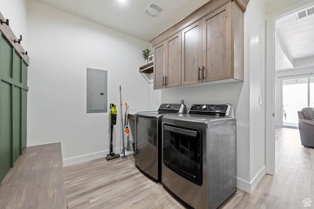 507 N 3650 W, Hurricane, UT 84737 - washroom featuring electric panel, separate washer and dryer, cabinet space, light wood finished floors, and a barn door