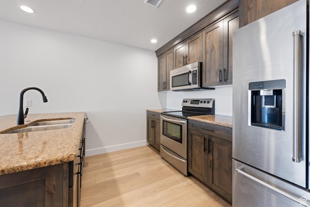 507 N 3650 W, Hurricane, UT 84737 - kitchen with stainless steel appliances, dark brown cabinetry, light stone countertops, and recessed lighting