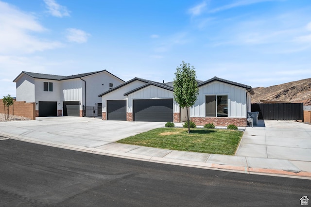 507 N 3650 W, Hurricane, UT 84737 - modern farmhouse with concrete driveway, a garage, and board and batten siding