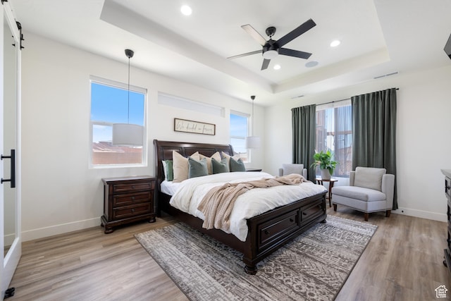 507 N 3650 W, Hurricane, UT 84737 - bedroom featuring a tray ceiling, light wood-style flooring, recessed lighting, a barn door, and ceiling fan