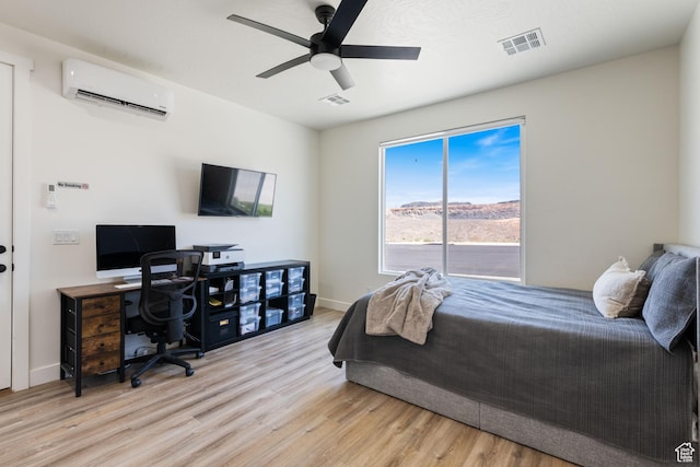 507 N 3650 W, Hurricane, UT 84737 - bedroom featuring a wall mounted air conditioner, light wood finished floors, a desk, and a ceiling fan