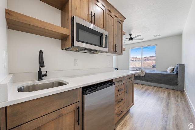 507 N 3650 W, Hurricane, UT 84737 - kitchen with stainless steel appliances, open shelves, a ceiling fan, light wood-style flooring, and light countertops
