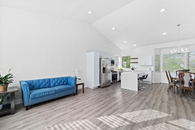 9375 S Laurel Ridge Cir, West Jordan, UT 84088 - living area with high vaulted ceiling, recessed lighting, light wood-style flooring, and a chandelier