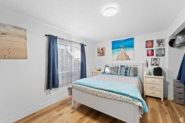 9375 S Laurel Ridge Cir, West Jordan, UT 84088 - bedroom featuring light wood finished floors and a textured ceiling
