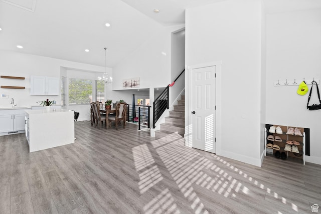 9375 S Laurel Ridge Cir, West Jordan, UT 84088 - living room with high vaulted ceiling, light wood-style flooring, stairs, a chandelier, and recessed lighting
