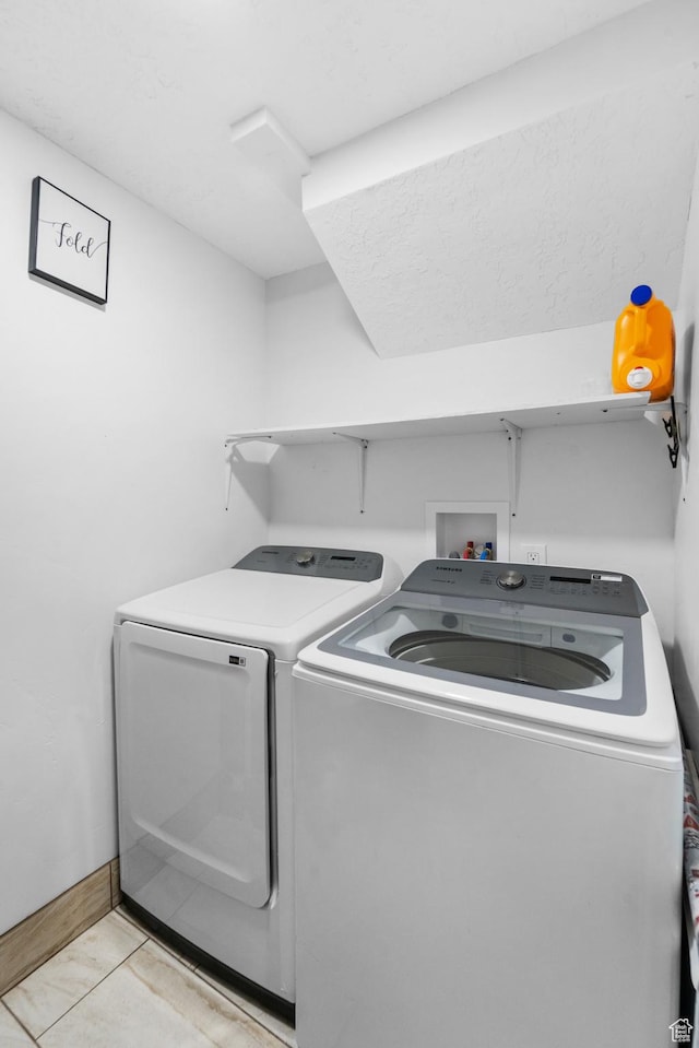 9375 S Laurel Ridge Cir, West Jordan, UT 84088 - washroom with washer and clothes dryer and light tile patterned floors