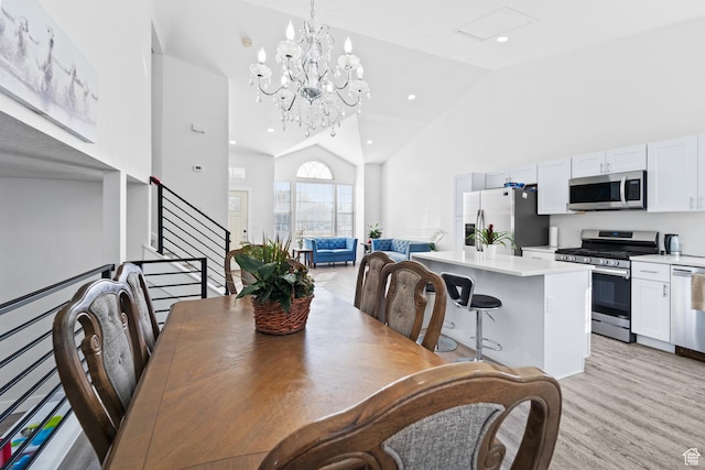 9375 S Laurel Ridge Cir, West Jordan, UT 84088 - dining space with high vaulted ceiling, light wood-style flooring, stairs, a chandelier, and recessed lighting