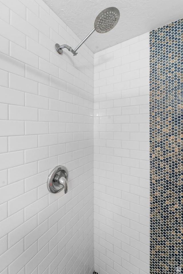 9375 S Laurel Ridge Cir, West Jordan, UT 84088 - bathroom view of a tile shower and a textured ceiling