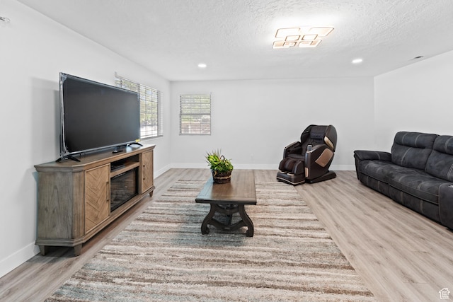9375 S Laurel Ridge Cir, West Jordan, UT 84088 - living room with light wood-style flooring, a textured ceiling, and recessed lighting