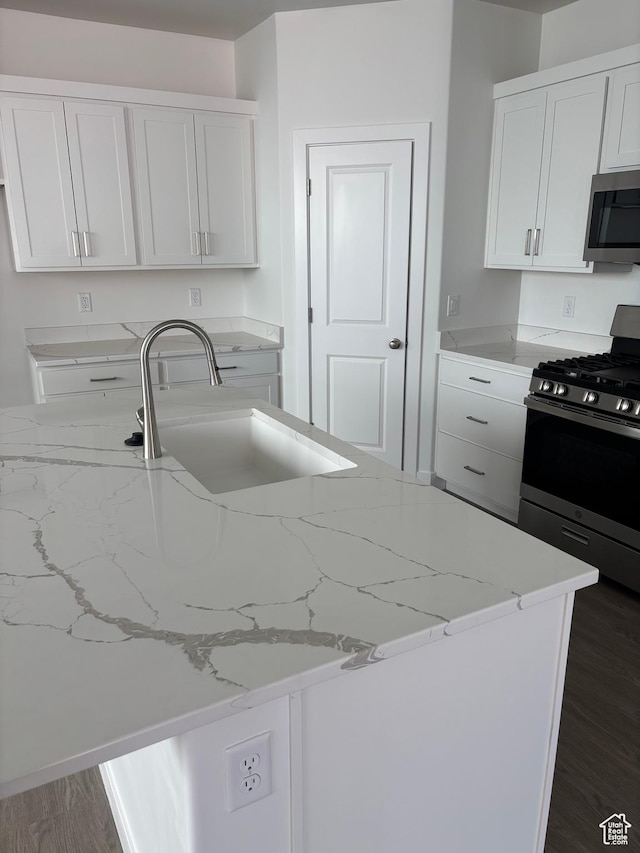 6126 S Kelly Ln, St George, UT 84790 - kitchen with stainless steel appliances, light stone countertops, white cabinets, and dark wood finished floors