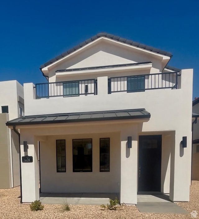 6126 S Kelly Ln, St George, UT 84790 - back of house featuring a balcony, a standing seam roof, stucco siding, and a metal roof