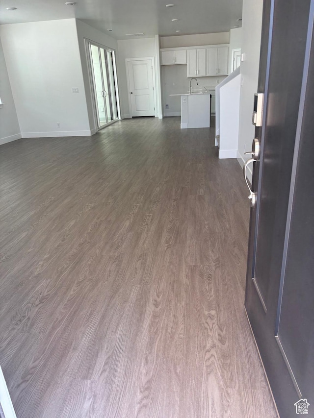 6126 S Kelly Ln, St George, UT 84790 - unfurnished living room featuring a sink and dark wood-type flooring