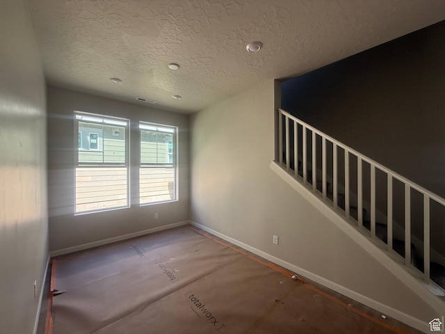 6184 W 11800 S Unit 508, Riverton, UT 84096 - spare room with a textured ceiling and stairway