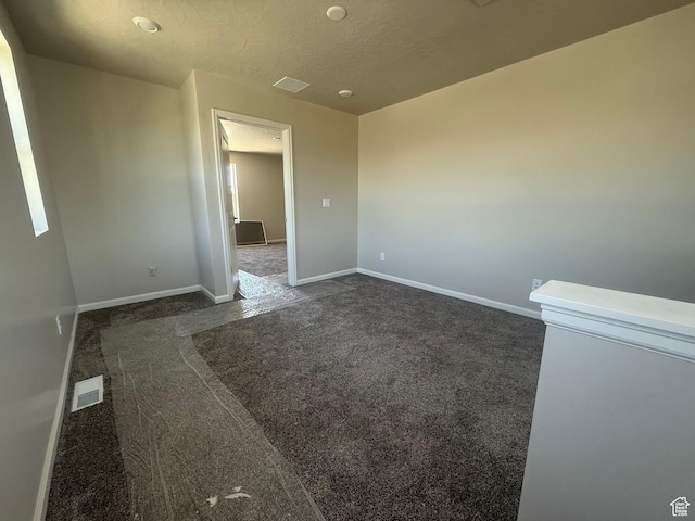 6184 W 11800 S Unit 508, Riverton, UT 84096 - unfurnished room with dark carpet and a textured ceiling