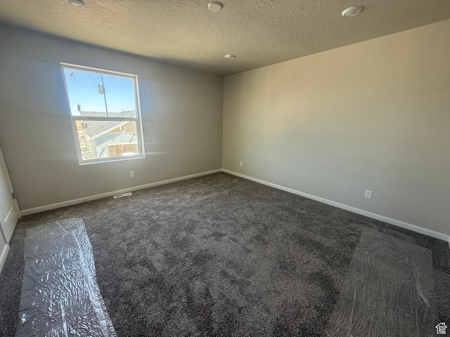 6184 W 11800 S Unit 508, Riverton, UT 84096 - empty room with dark colored carpet and a textured ceiling