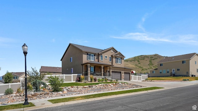 14267 S Palo Alto Dr, Herriman, UT 84096 - traditional-style house with a garage, concrete driveway, a mountain view, stucco siding, and a residential view