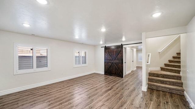 14267 S Palo Alto Dr, Herriman, UT 84096 - foyer entrance featuring a barn door, wood finished floors, stairs, and recessed lighting