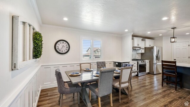 14267 S Palo Alto Dr, Herriman, UT 84096 - dining area featuring dark wood finished floors, ornamental molding, recessed lighting, a decorative wall, and wainscoting