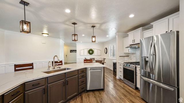 14267 S Palo Alto Dr, Herriman, UT 84096 - kitchen featuring appliances with stainless steel finishes, under cabinet range hood, wine cooler, white cabinetry, and crown molding