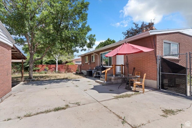 3524 W Meadowbrook Dr, West Valley City, UT 84119 - back of house with brick siding and a patio