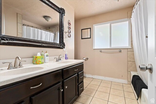 3524 W Meadowbrook Dr, West Valley City, UT 84119 - full bathroom with double vanity, a textured ceiling, tile patterned floors, and shower / bathtub combination with curtain