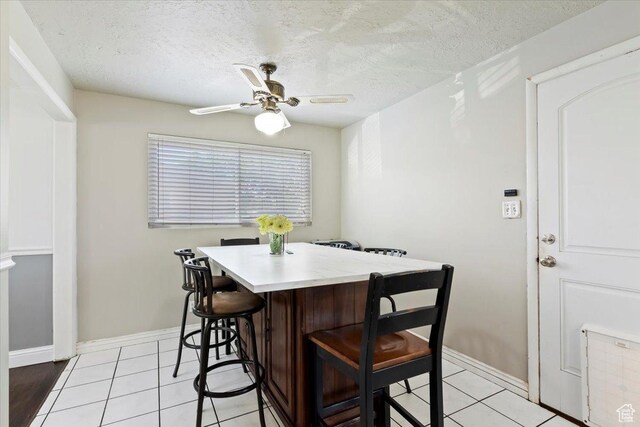 3524 W Meadowbrook Dr, West Valley City, UT 84119 - dining area with ceiling fan, a textured ceiling, and light tile patterned flooring
