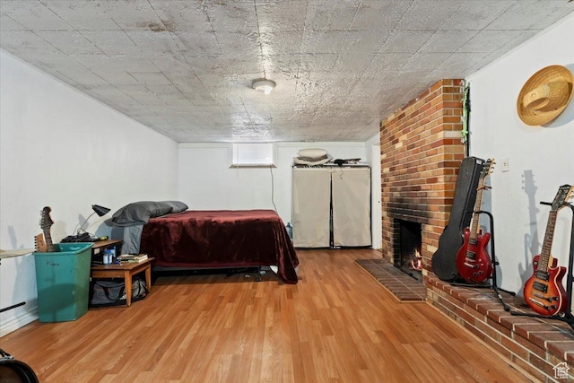 3524 W Meadowbrook Dr, West Valley City, UT 84119 - bedroom with wood finished floors and a brick fireplace