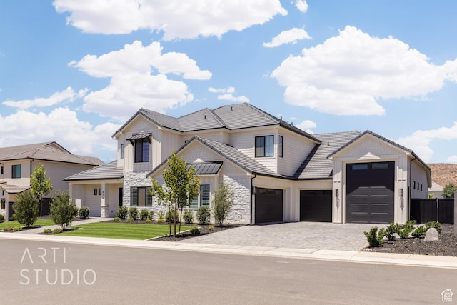 671 E Arina Way, Washington, UT 84780 - view of front of property featuring an attached garage, stone siding, decorative driveway, a tile roof, and board and batten siding