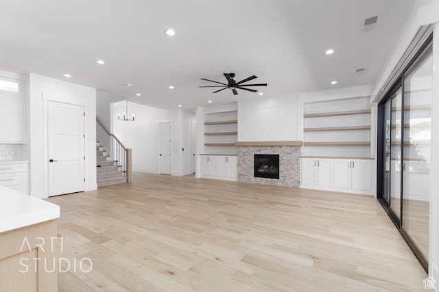671 E Arina Way, Washington, UT 84780 - unfurnished living room featuring stairway, recessed lighting, a ceiling fan, light wood finished floors, and a fireplace