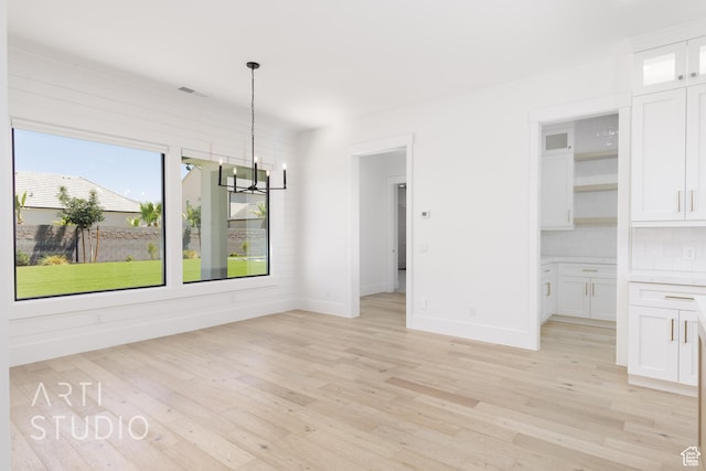 671 E Arina Way, Washington, UT 84780 - unfurnished dining area with a chandelier and light wood finished floors