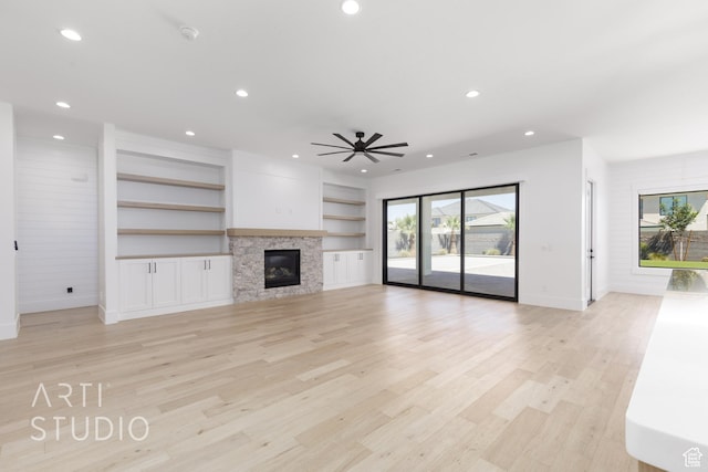 671 E Arina Way, Washington, UT 84780 - unfurnished living room with healthy amount of natural light, recessed lighting, light wood-type flooring, a ceiling fan, and a glass covered fireplace