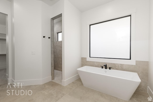 671 E Arina Way, Washington, UT 84780 - bathroom with a freestanding bath and baseboards