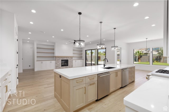 671 E Arina Way, Washington, UT 84780 - kitchen with dishwasher, a glass covered fireplace, recessed lighting, light wood-type flooring, and a kitchen island with sink
