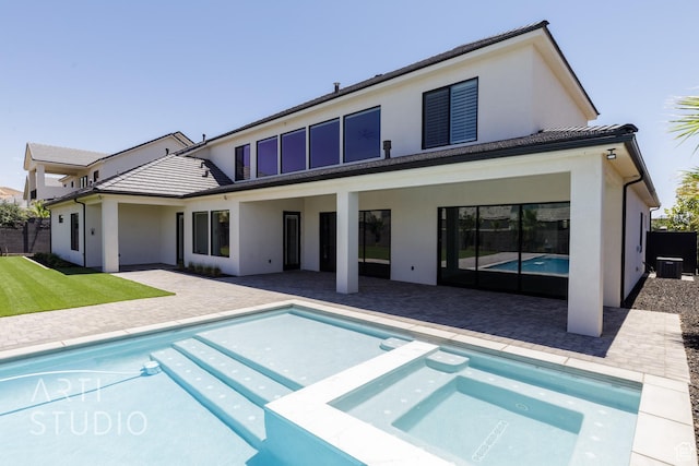 671 E Arina Way, Washington, UT 84780 - back of property with stucco siding, a pool with connected hot tub, and a patio area