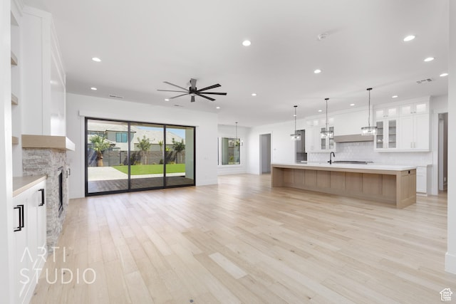 671 E Arina Way, Washington, UT 84780 - kitchen featuring open floor plan, decorative backsplash, a ceiling fan, light countertops, and white cabinets
