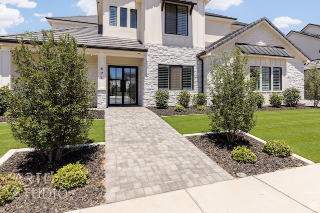 671 E Arina Way, Washington, UT 84780 - view of front of property with stone siding, a front yard, board and batten siding, and french doors