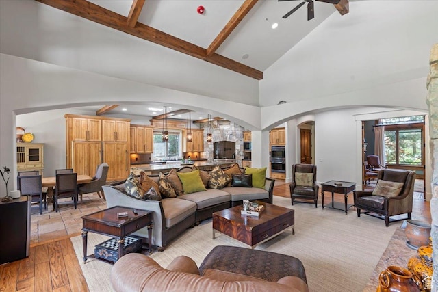 3149 E 9800 S, Sandy, UT 84092 - living room with arched walkways, beam ceiling, high vaulted ceiling, a ceiling fan, and light wood-style floors